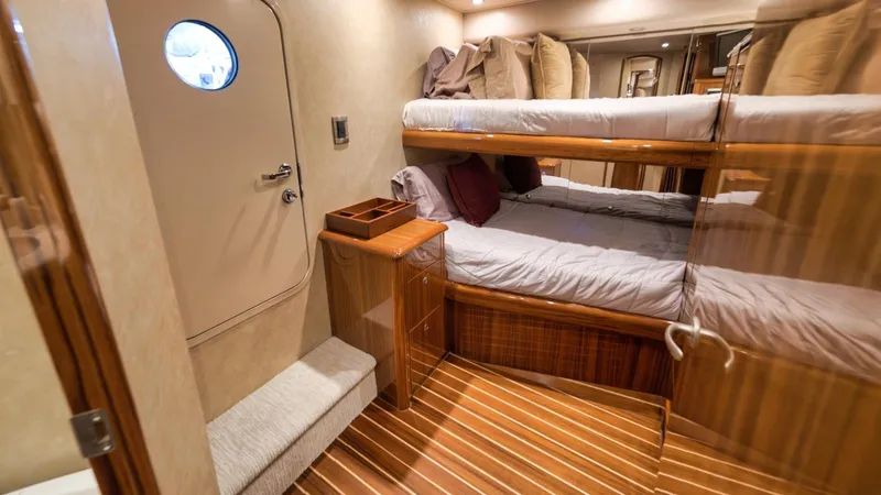 Nailed It Yacht Photos Pics Luxurious cabin interior of 2008 Viking 74EB yacht with bunk beds and wooden flooring.