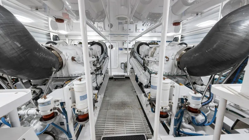Nailed It Yacht Photos Pics Engine room of a 2008 Viking 74EB yacht, featuring dual engines and complex machinery.