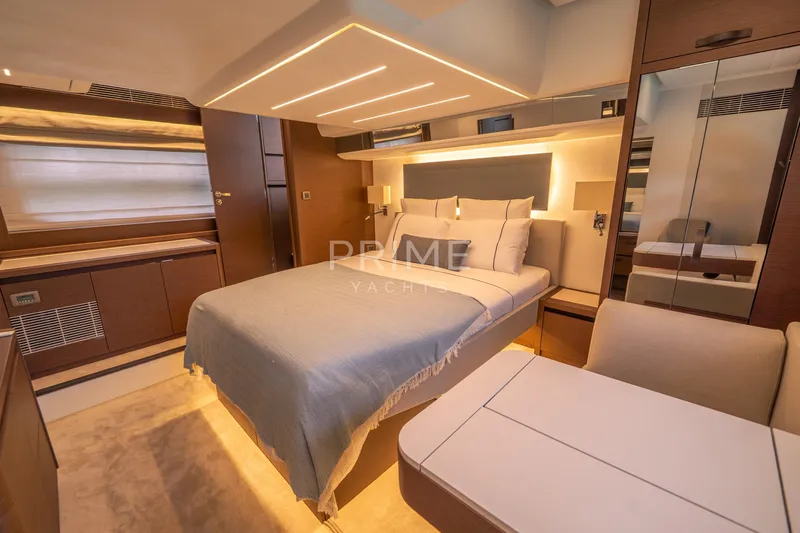 One Step Closer Yacht Photos Pics Luxurious bedroom interior of 2024 Prestige 590 yacht, featuring modern design and ambient lighting.