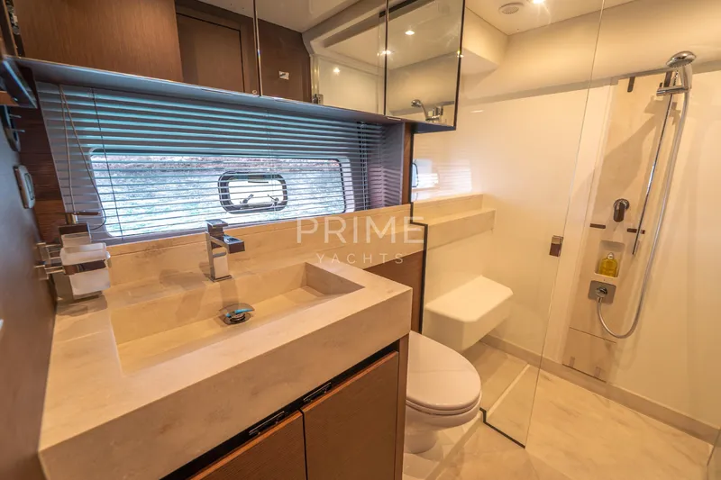 One Step Closer Yacht Photos Pics Luxurious bathroom in 2024 Prestige 590 yacht with modern fixtures and elegant design.