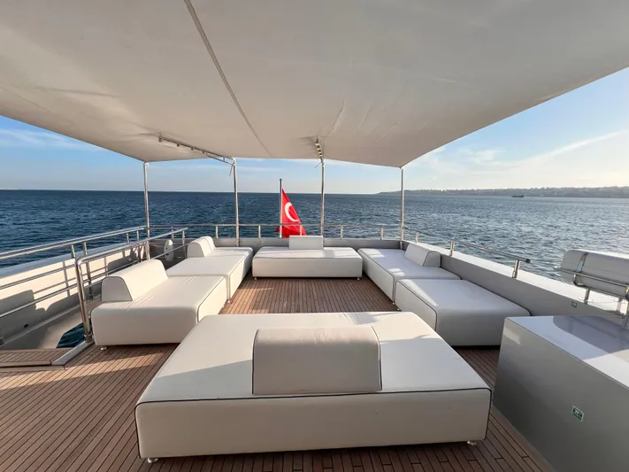 Aquila Yacht Photos Pics Luxurious deck of 2015 Mengi Yay 36M Pennon yacht with white seating and Turkish flag.