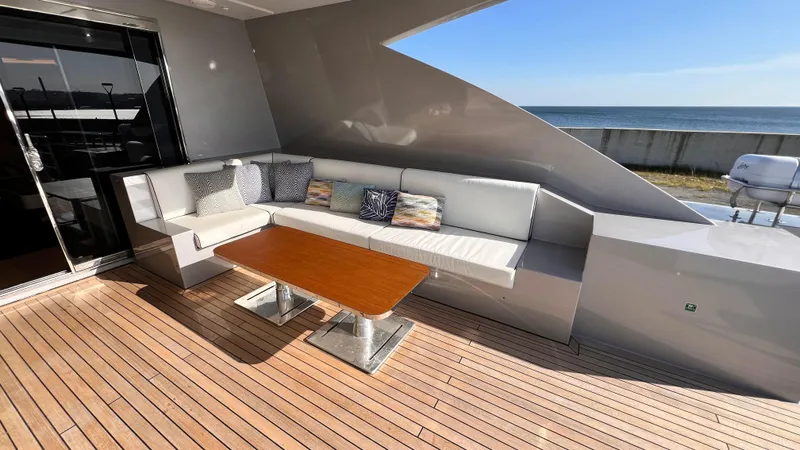 Aquila Yacht Photos Pics Luxury yacht deck with modern seating, wooden table, and ocean view. Mengi Yay 36M Pennon, 2015.
