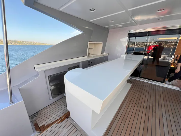 Aquila Yacht Photos Pics Luxurious 2015 Mengi Yay 36M Pennon yacht deck with sleek bar and ocean view.