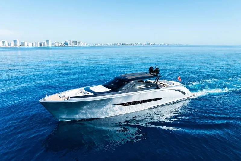 Fellowship II Yacht Photos Pics Luxury 2023 Wajer 77 yacht cruising on open blue sea near city skyline.