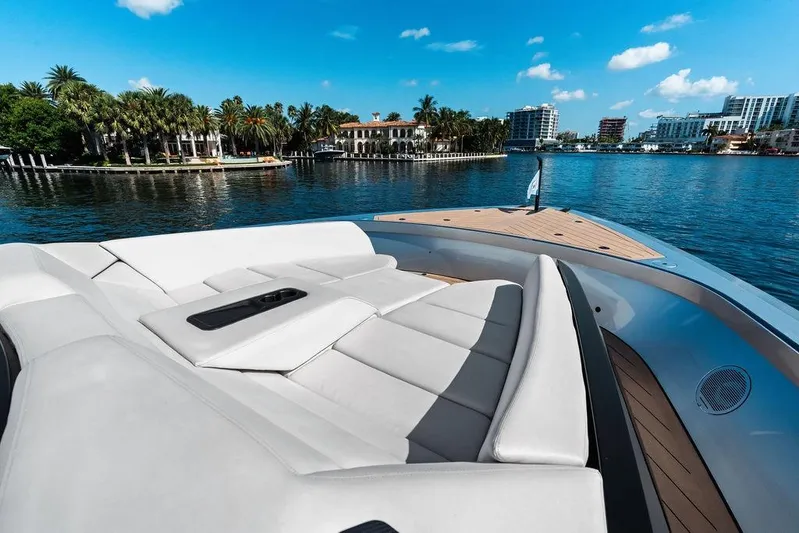 Fellowship II Yacht Photos Pics Luxurious 2023 Wajer 77 yacht with spacious deck, cruising near waterfront homes.