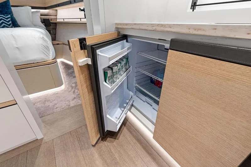 Fellowship II Yacht Photos Pics Modern interior of 2023 Wajer 77 yacht featuring an open mini fridge.