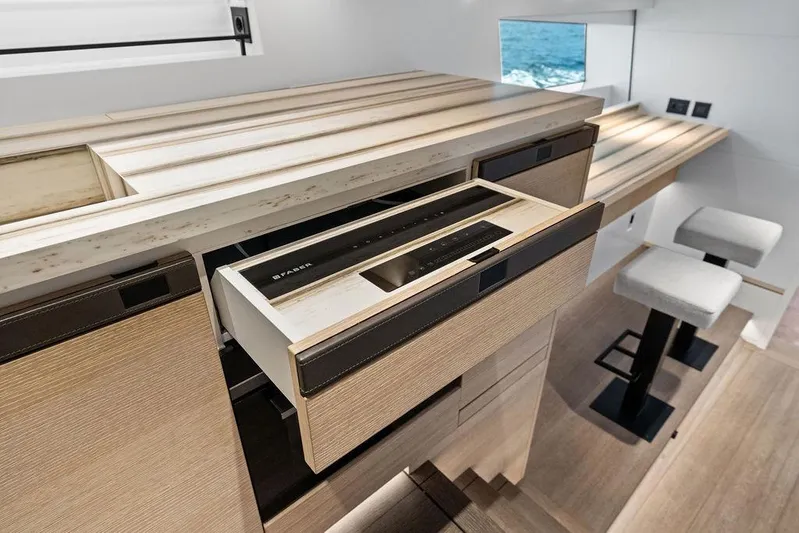 Fellowship II Yacht Photos Pics Luxurious interior of 2023 Wajer 77 yacht with modern cabinetry and seating.