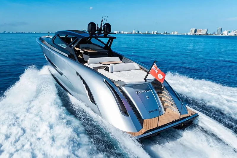 Fellowship II Yacht Photos Pics Luxury 2023 Wajer 77 yacht cruising on open blue sea, city skyline in background.