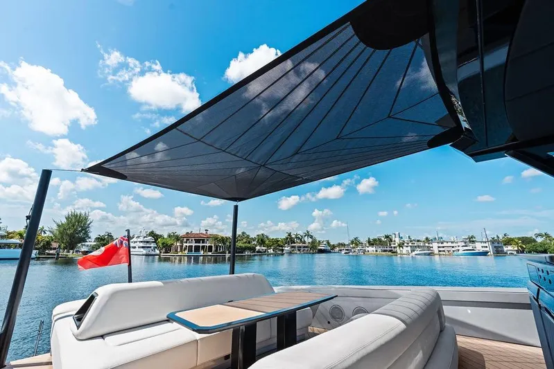 Fellowship II Yacht Photos Pics Luxurious 2023 Wajer 77 yacht with sunshade, docked by scenic waterfront.