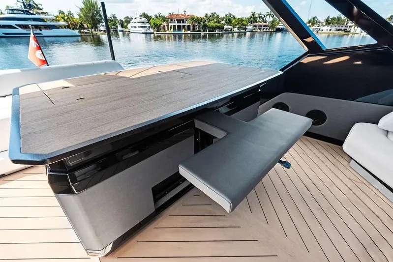 Fellowship II Yacht Photos Pics Luxury interior of 2023 Wajer 77 yacht with sleek wooden table and seating.