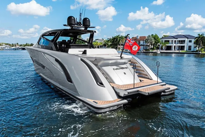 Fellowship II Yacht Photos Pics Luxury 2023 Wajer 77 yacht cruising on a sunny day, with elegant design and waterfront homes.