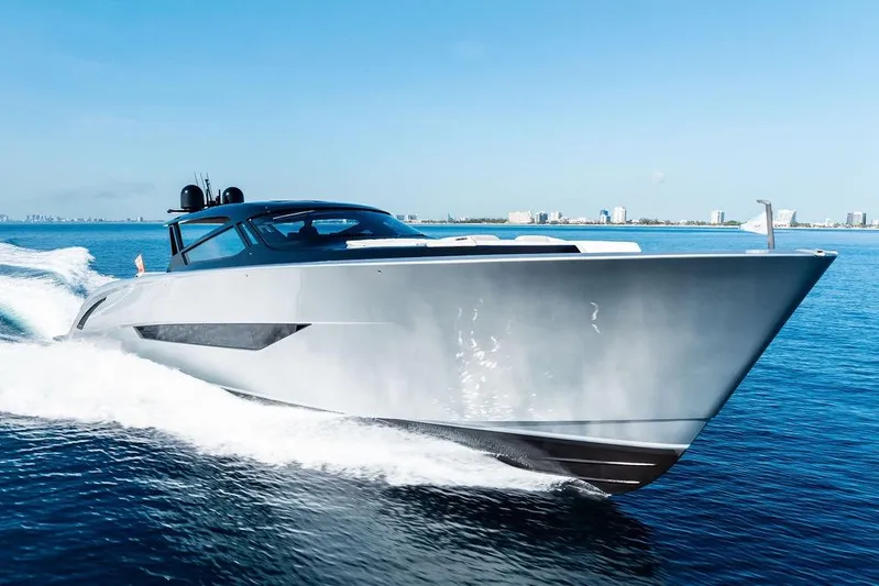 Fellowship II Yacht Photos Pics 2023 Wajer 77 luxury yacht cruising on open water, city skyline in background.