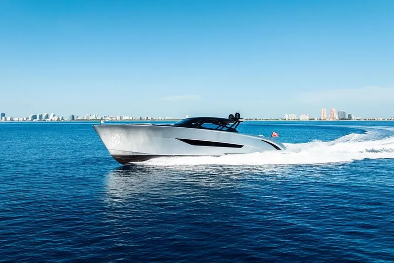 Fellowship II Yacht Photos Pics Luxury Wajer 77 yacht cruising on blue ocean, 2023 model, city skyline in background.
