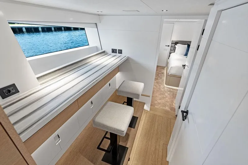 Fellowship II Yacht Photos Pics Luxurious interior of 2023 Wajer 77 yacht with modern seating and scenic window view.