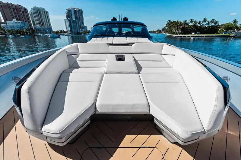 Fellowship II Yacht Photos Pics Luxurious 2023 Wajer 77 yacht with spacious deck seating, docked in a scenic waterfront location.