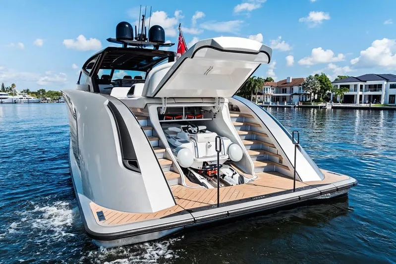 Fellowship II Yacht Photos Pics Luxury Wajer 77 yacht with open garage, docked by waterfront homes, 2023 model.