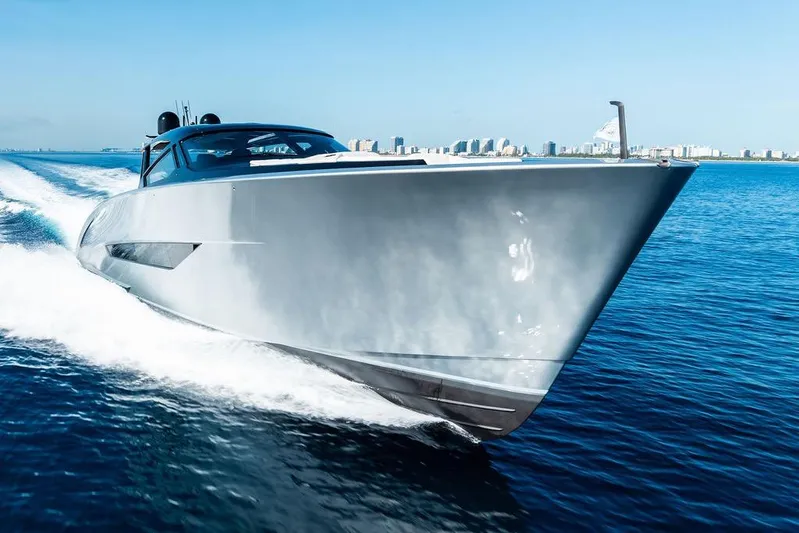 Fellowship II Yacht Photos Pics 2023 Wajer 77 yacht cruising on open water, city skyline in background.