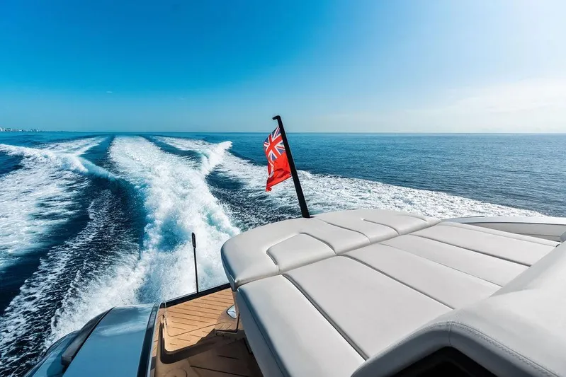 Fellowship II Yacht Photos Pics Luxury Wajer 77 yacht cruising on open sea, 2023 model, with flag and wake trail.