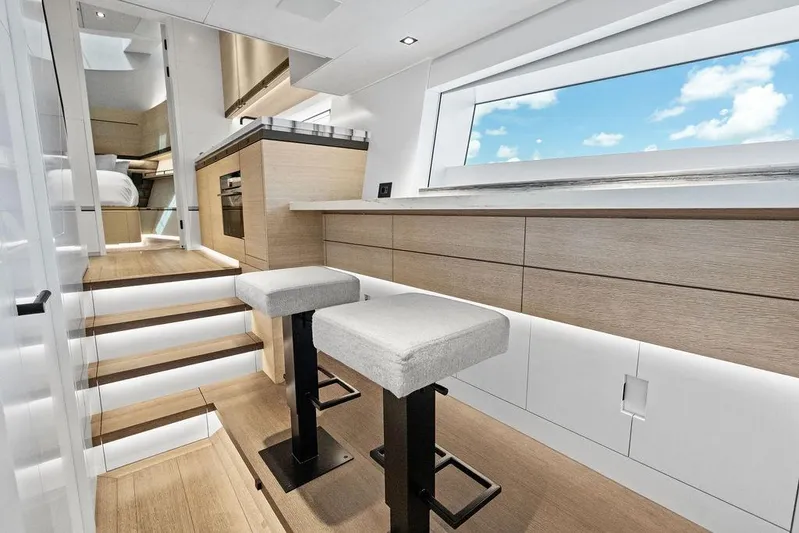 Fellowship II Yacht Photos Pics Luxurious interior of 2023 Wajer 77 yacht with modern kitchen and seating area.