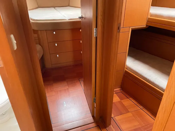 Dream Again II Yacht Photos Pics Interior of 2003 Oyster 53 yacht with wooden cabinetry and cozy sleeping quarters.