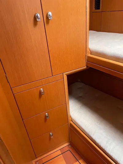 Dream Again II Yacht Photos Pics Wooden interior of 2003 Oyster 53 yacht with bunk beds and storage.