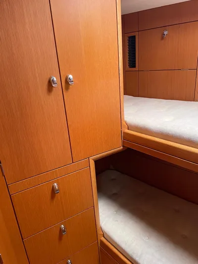 Dream Again II Yacht Photos Pics Interior of 2003 Oyster 53 yacht with wooden cabinetry and bunk beds.