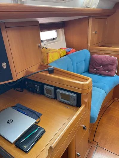 Dream Again II Yacht Photos Pics Interior of 2003 Oyster 53 yacht with navigation equipment and cozy seating area.
