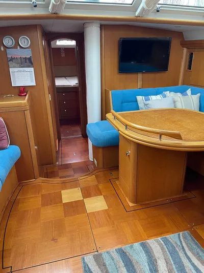 Dream Again II Yacht Photos Pics Interior of 2003 Oyster 53 yacht with wooden flooring and blue seating.