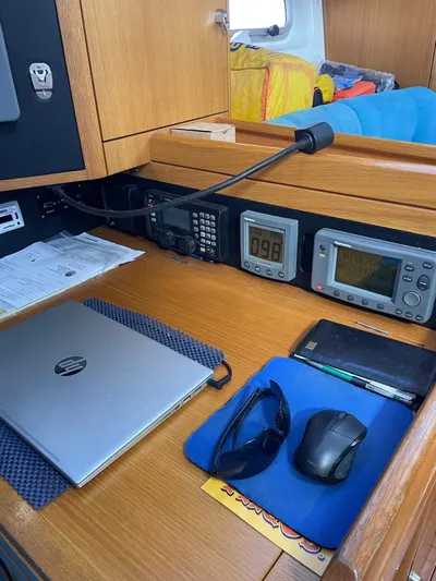 Dream Again II Yacht Photos Pics Navigation station on 2003 Oyster 53 yacht with electronics, laptop, and accessories.