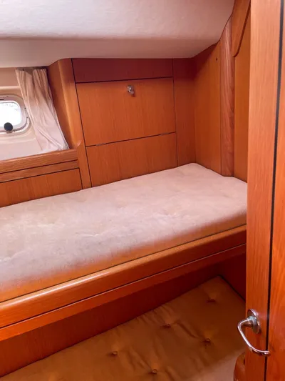 Dream Again II Yacht Photos Pics Cozy cabin interior of 2003 Oyster 53 yacht with wooden furnishings.