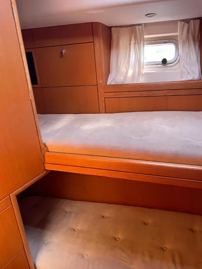 Dream Again II Yacht Photos Pics Interior cabin of 2003 Oyster 53 yacht with wooden finish and bunk beds.