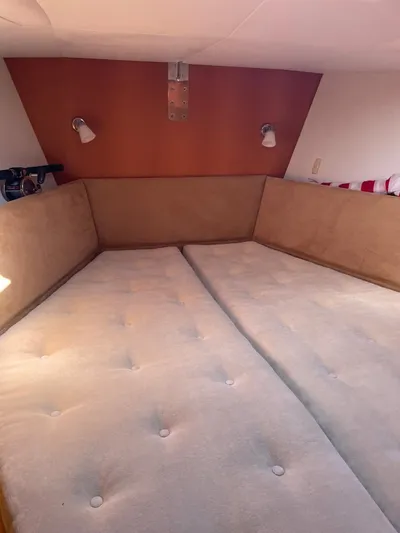 Dream Again II Yacht Photos Pics Cozy cabin bed in 2003 Oyster 53 yacht with beige upholstery and wall lamps.