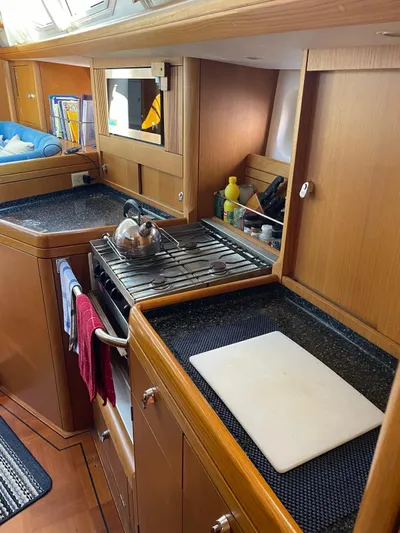 Dream Again II Yacht Photos Pics 2003 Oyster 53 yacht kitchen with wooden cabinetry and modern appliances.