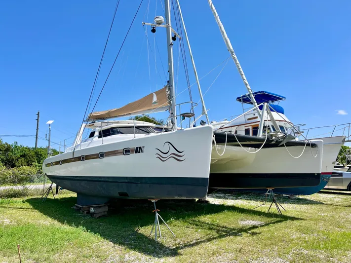 Gods Grace Yacht Photos Pics Voyage Yachts 500 catamaran, 2010 model, on land under clear blue sky.