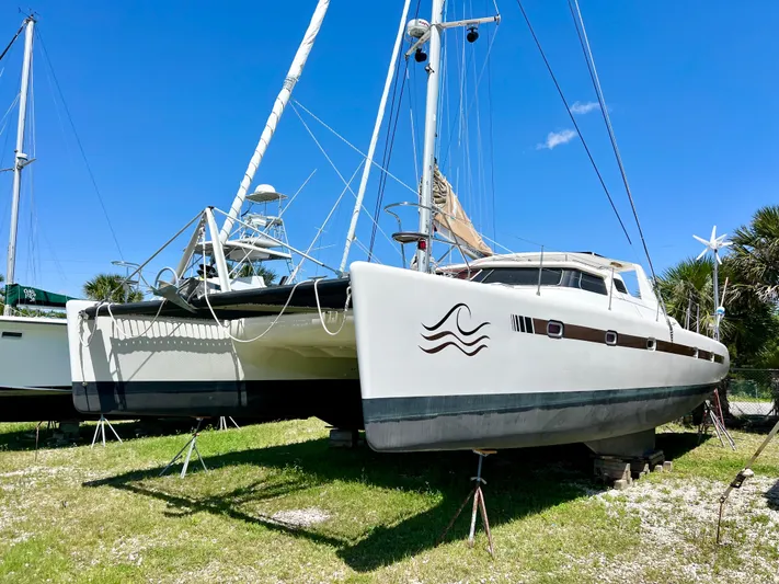 Gods Grace Yacht Photos Pics 2010 Voyage Yachts 500 catamaran on land, under clear blue sky.