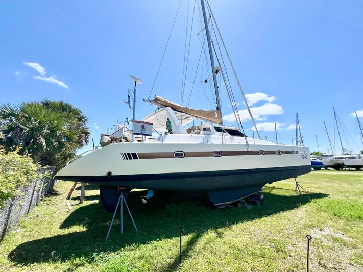 Gods Grace Yacht Photos Pics Voyage Yachts 500 catamaran, 2010 model, on land under clear blue sky.