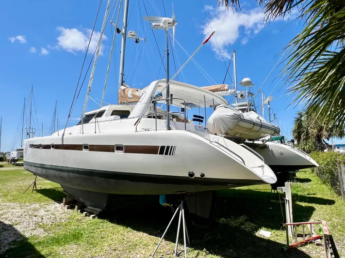 Gods Grace Yacht Photos Pics Voyage Yachts 500 catamaran, 2010 model, on land under clear blue sky.