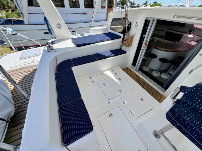 Gods Grace Yacht Photos Pics Spacious deck of 2010 Voyage Yachts 500 with blue cushioned seating and open cabin entrance.