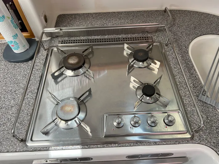 Gods Grace Yacht Photos Pics Stainless steel four-burner stove on a 2010 Voyage Yachts 500, set in a granite countertop.