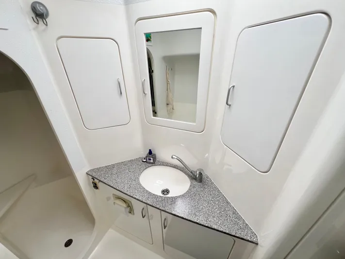 Gods Grace Yacht Photos Pics Bathroom interior of 2010 Voyage Yachts 500 with sink, mirror, and storage cabinets.