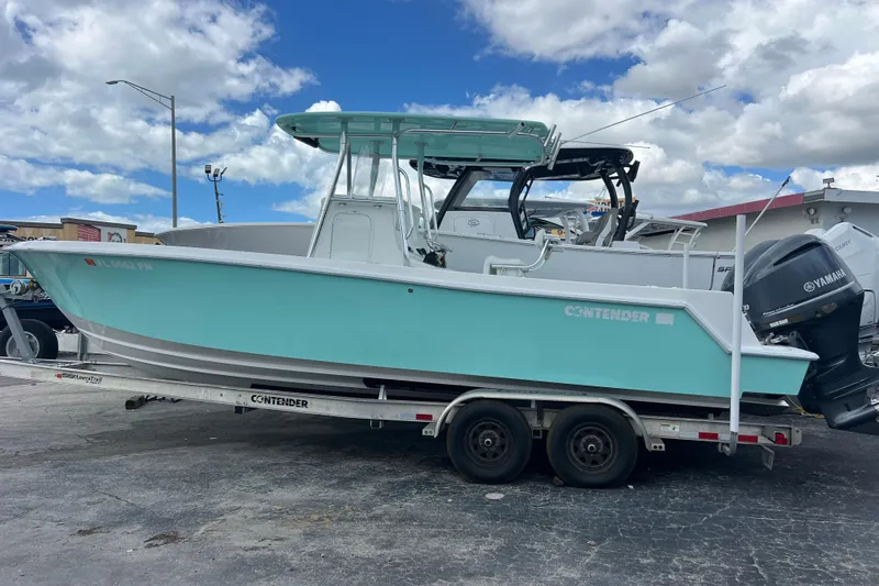  Yacht Photos Pics 2013 Contender 28 Sport boat on trailer, featuring Yamaha outboard motors, under a cloudy sky.