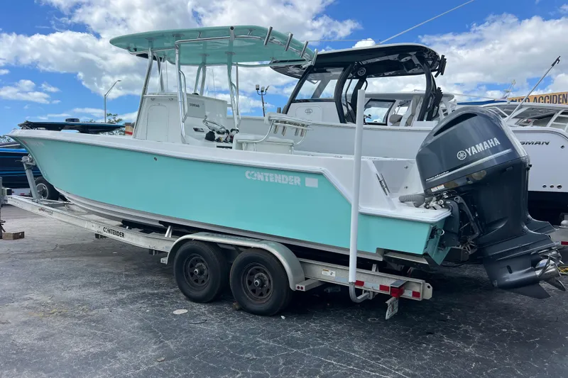  Yacht Photos Pics 2013 Contender 28 Sport boat on trailer with Yamaha outboard motor, under blue sky.
