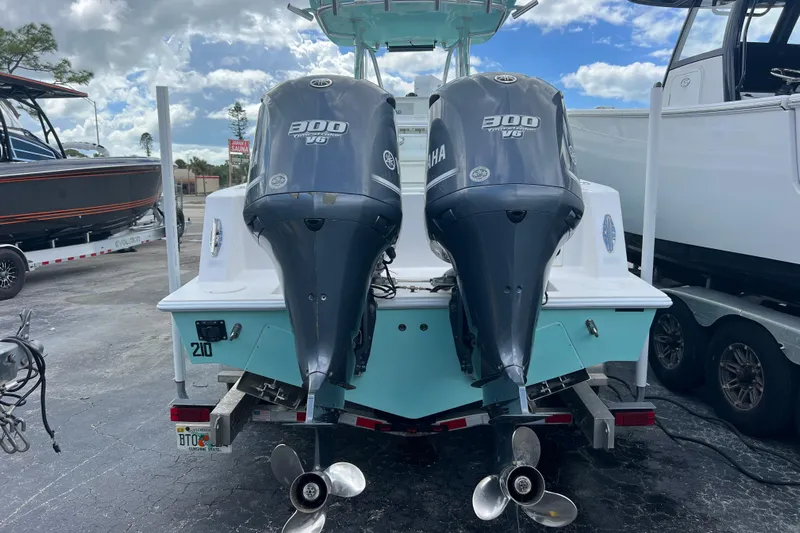  Yacht Photos Pics 2013 Contender 28 Sport boat with twin Yamaha 300 V6 engines, parked on a trailer.