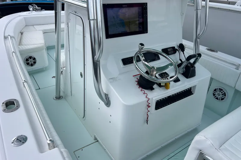  Yacht Photos Pics 2013 Contender 28 Sport boat cockpit with steering wheel, navigation screen, and seating.