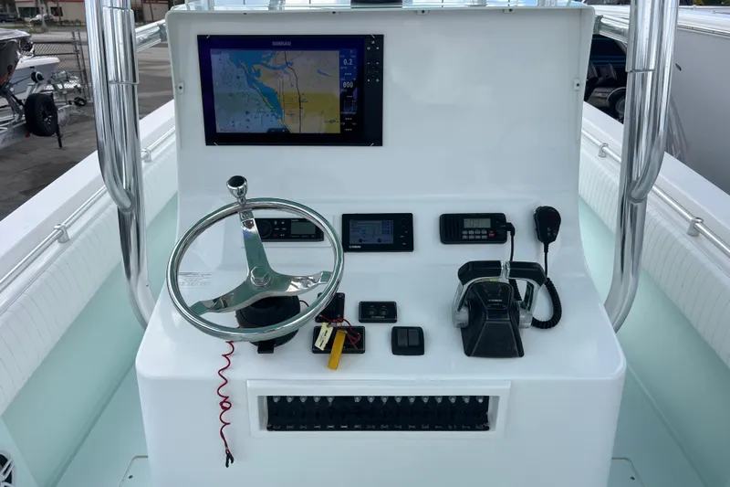  Yacht Photos Pics 2013 Contender 28 Sport boat dashboard with steering wheel and navigation equipment.