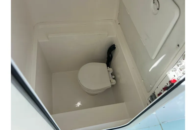  Yacht Photos Pics Interior of 2013 Contender 28 Sport boat showing compact marine toilet.