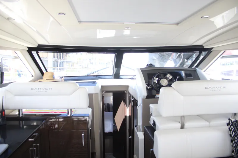 Skywalker Yacht Photos Pics Interior of 2018 Carver C43 Coupe yacht with white seating and modern dashboard.