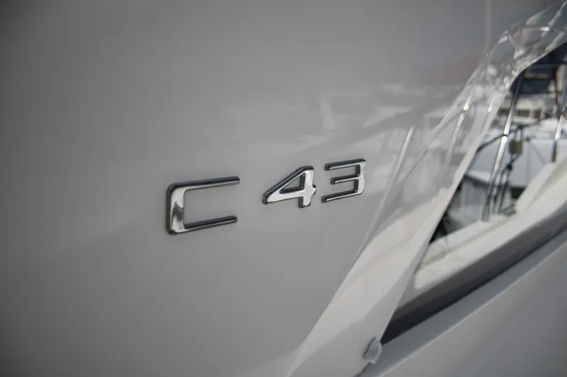Skywalker Yacht Photos Pics 2018 Carver C43 Coupe emblem on sleek white surface.