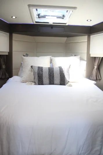 Skywalker Yacht Photos Pics Luxurious bedroom interior of 2018 Carver C43 Coupe with skylight and elegant bedding.