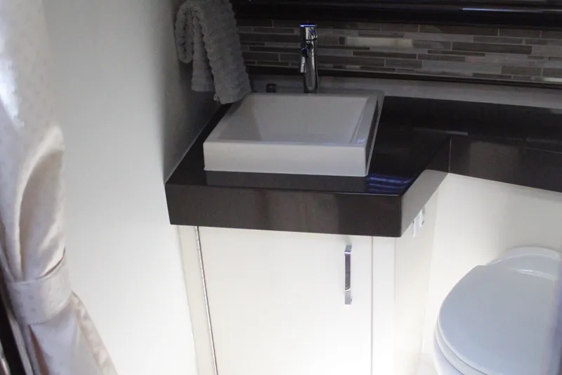 Skywalker Yacht Photos Pics Compact bathroom in 2018 Carver C43 Coupe with modern sink and sleek countertop.